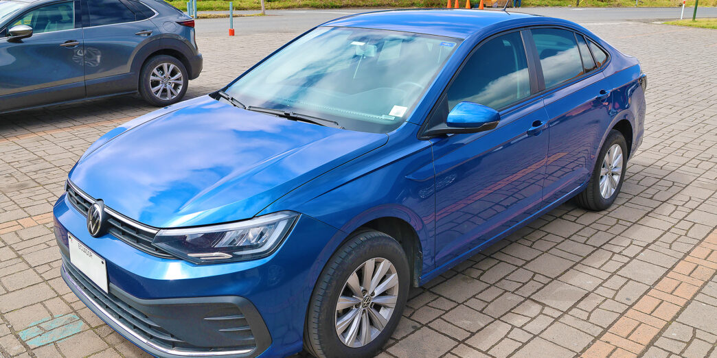 a blue car parked on a brick surface