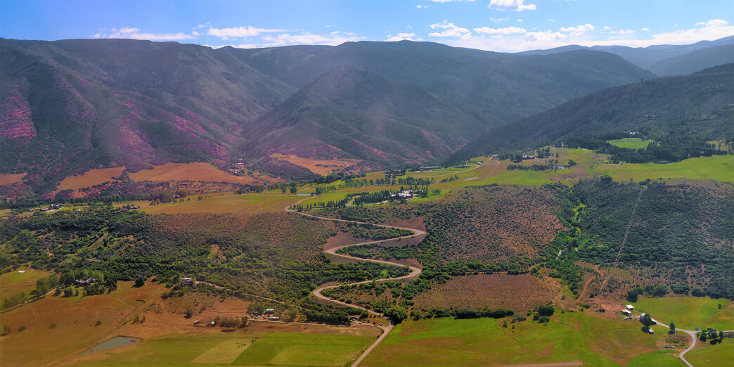 a winding road through a valley