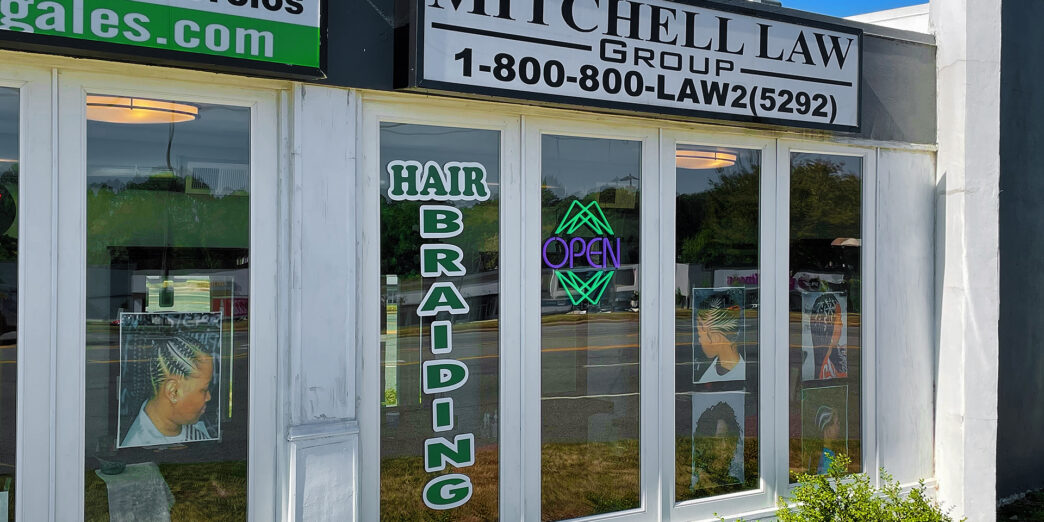 a store front with signs on windows