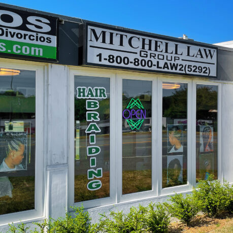 a store front with signs on windows