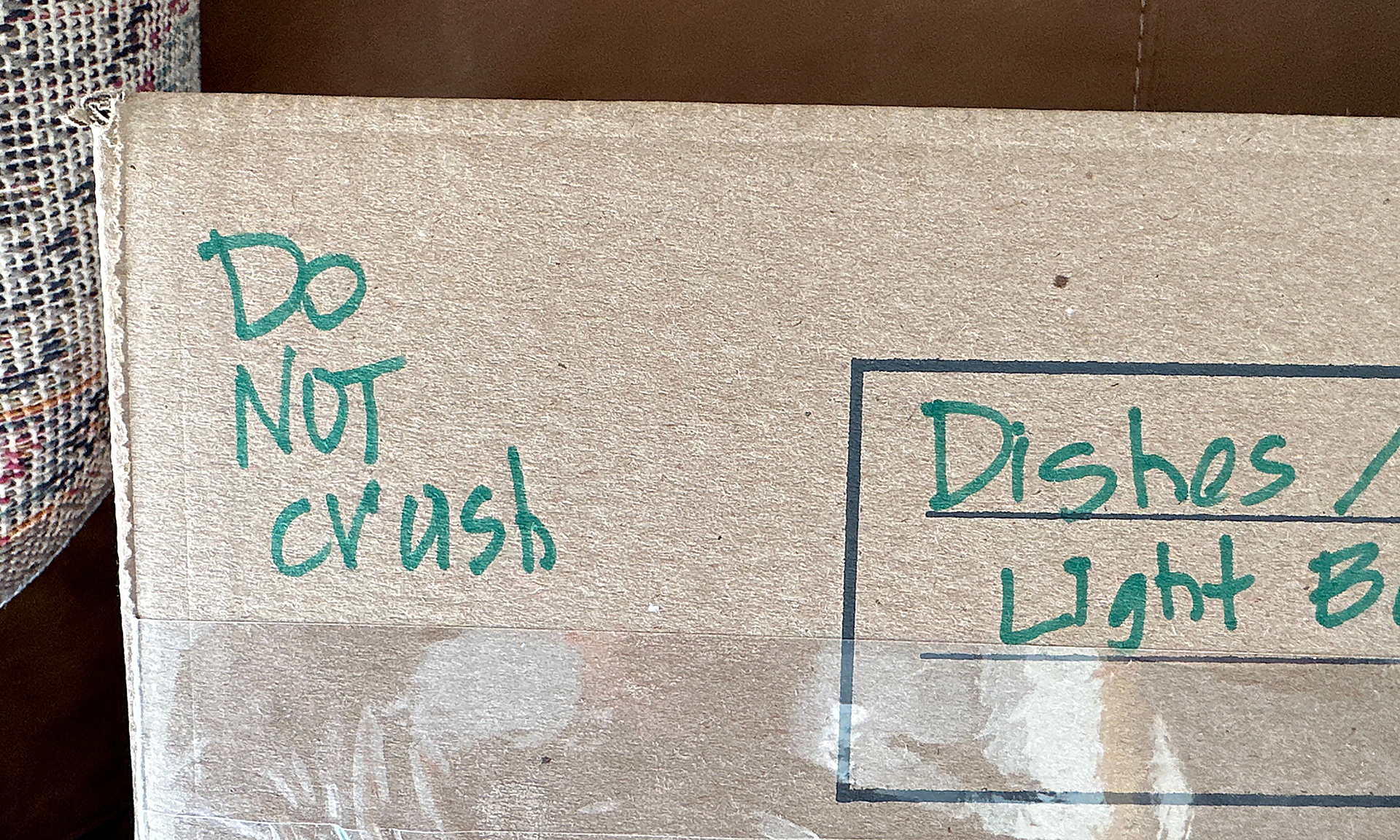 a cardboard box with green writing on it