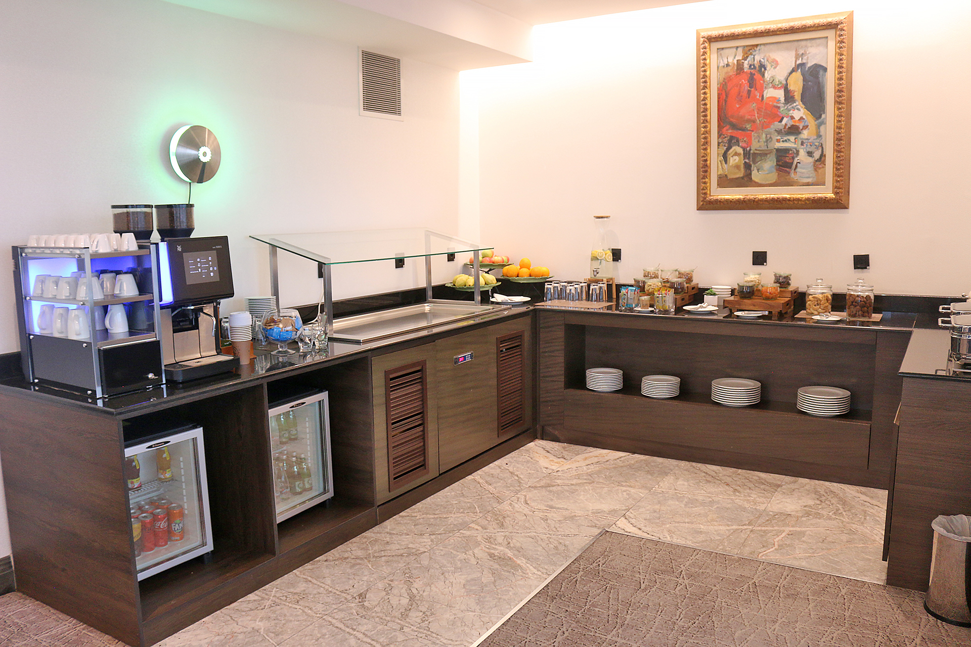 a room with a coffee bar and a refrigerator