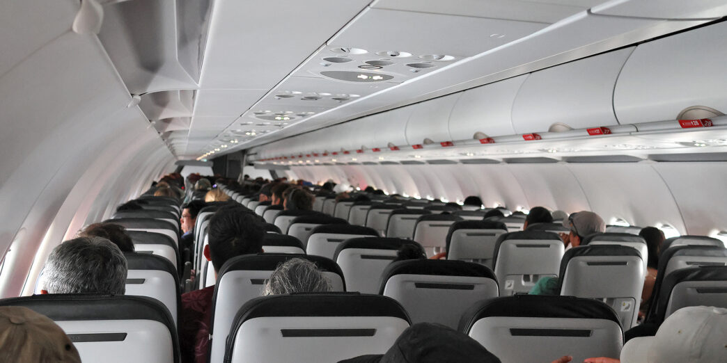 a group of people sitting in an airplane