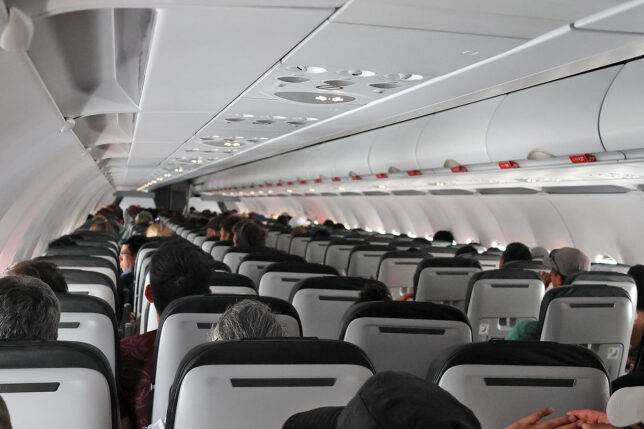 a group of people sitting in an airplane