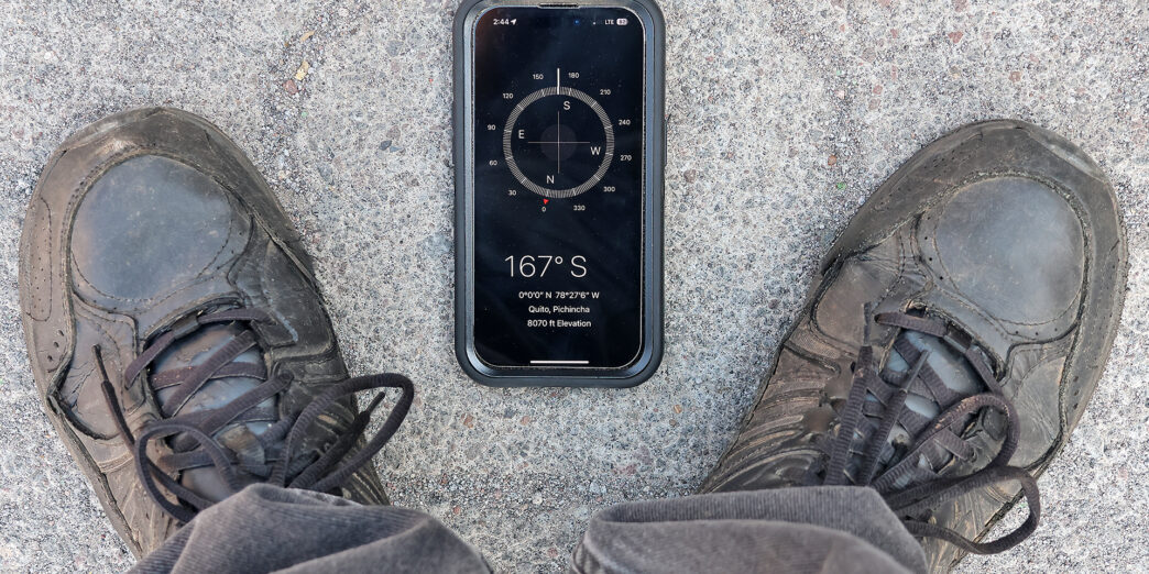 a phone and shoes on the ground
