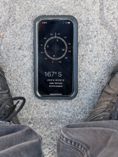 a phone and shoes on the ground