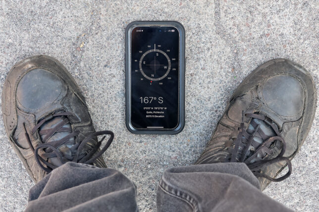 a phone and shoes on the ground
