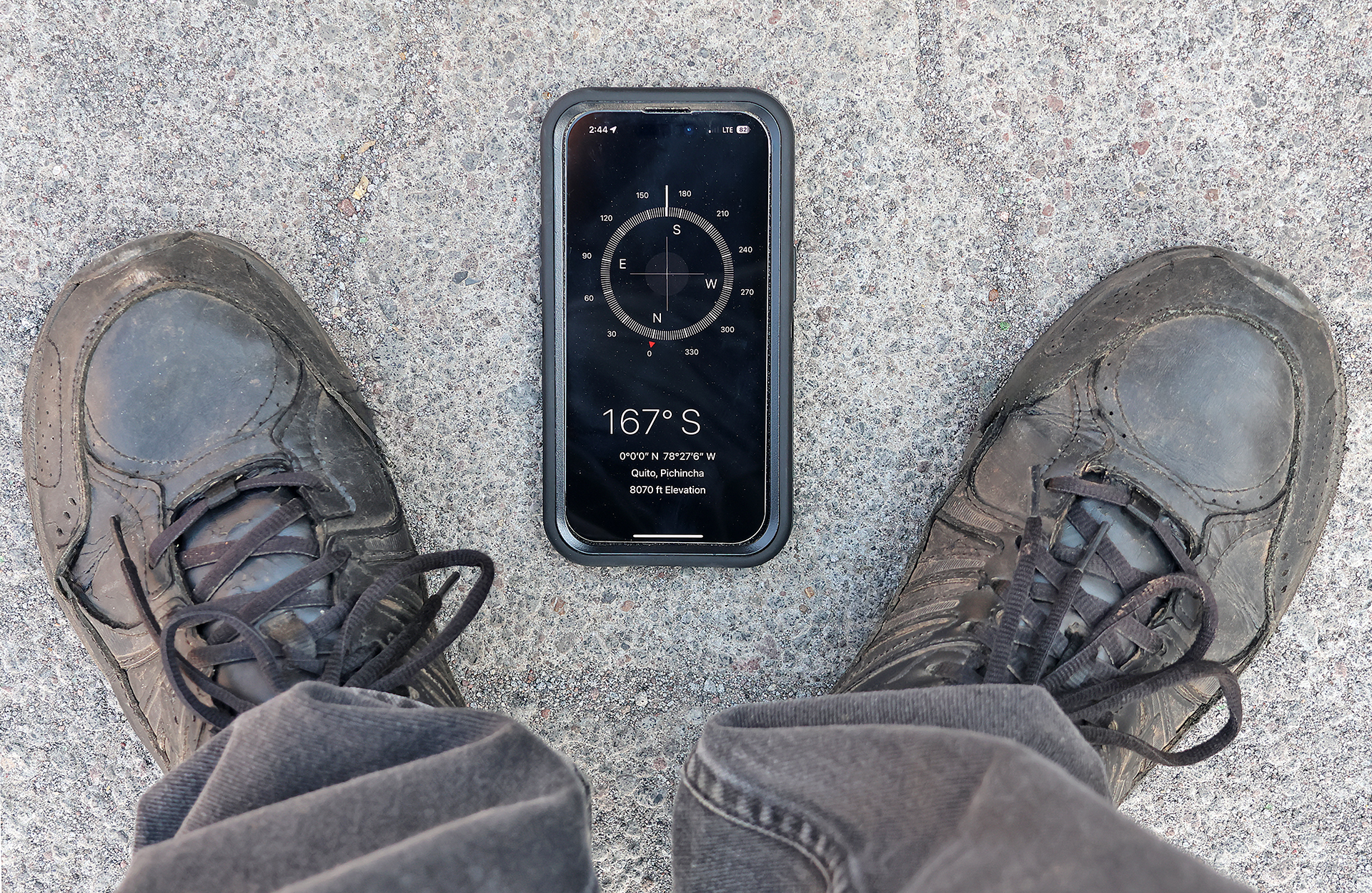 a phone and shoes on the ground