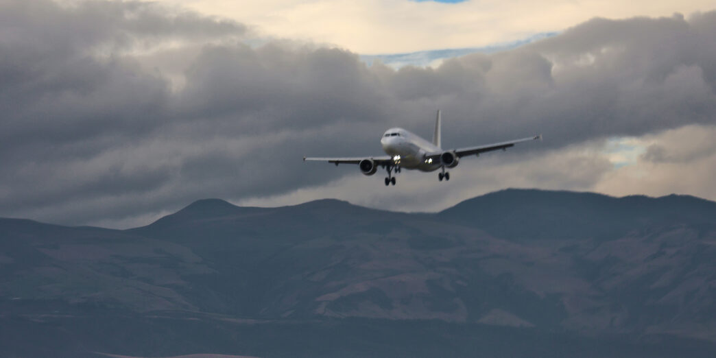 an airplane flying over mountains