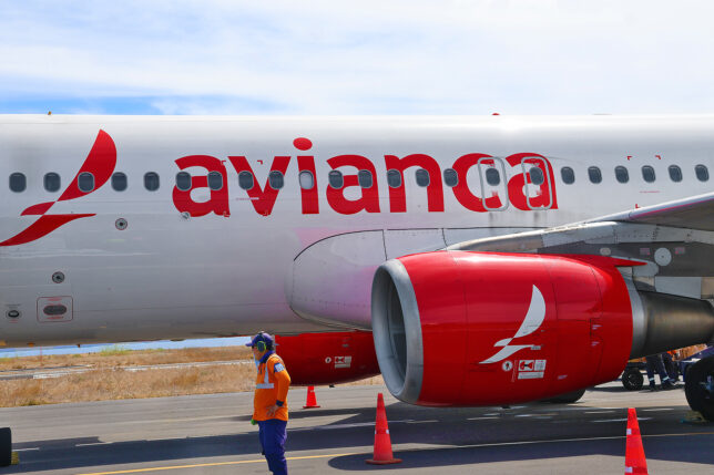 a man standing next to a large airplane