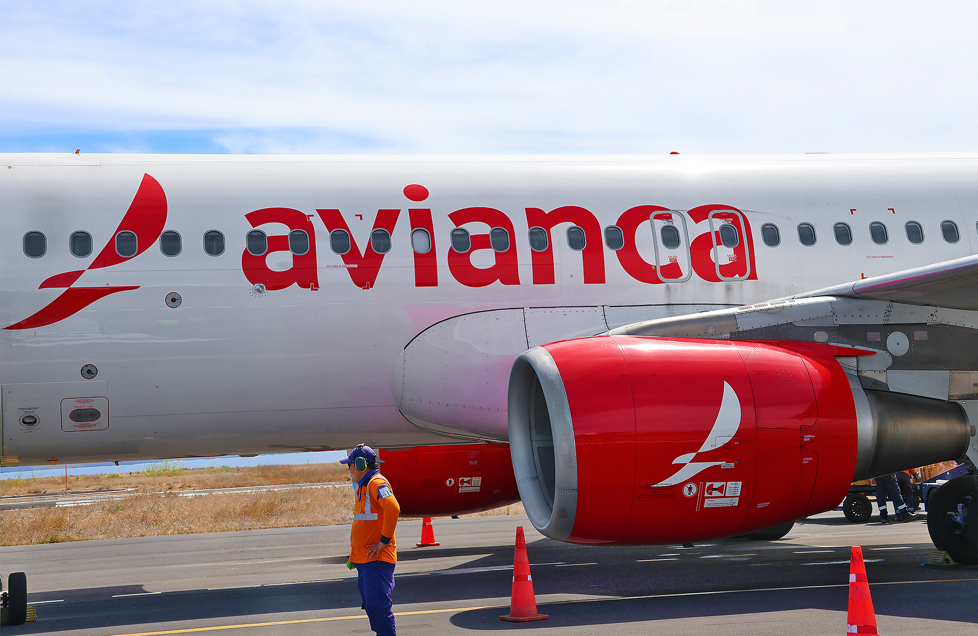 a man standing next to a large airplane
