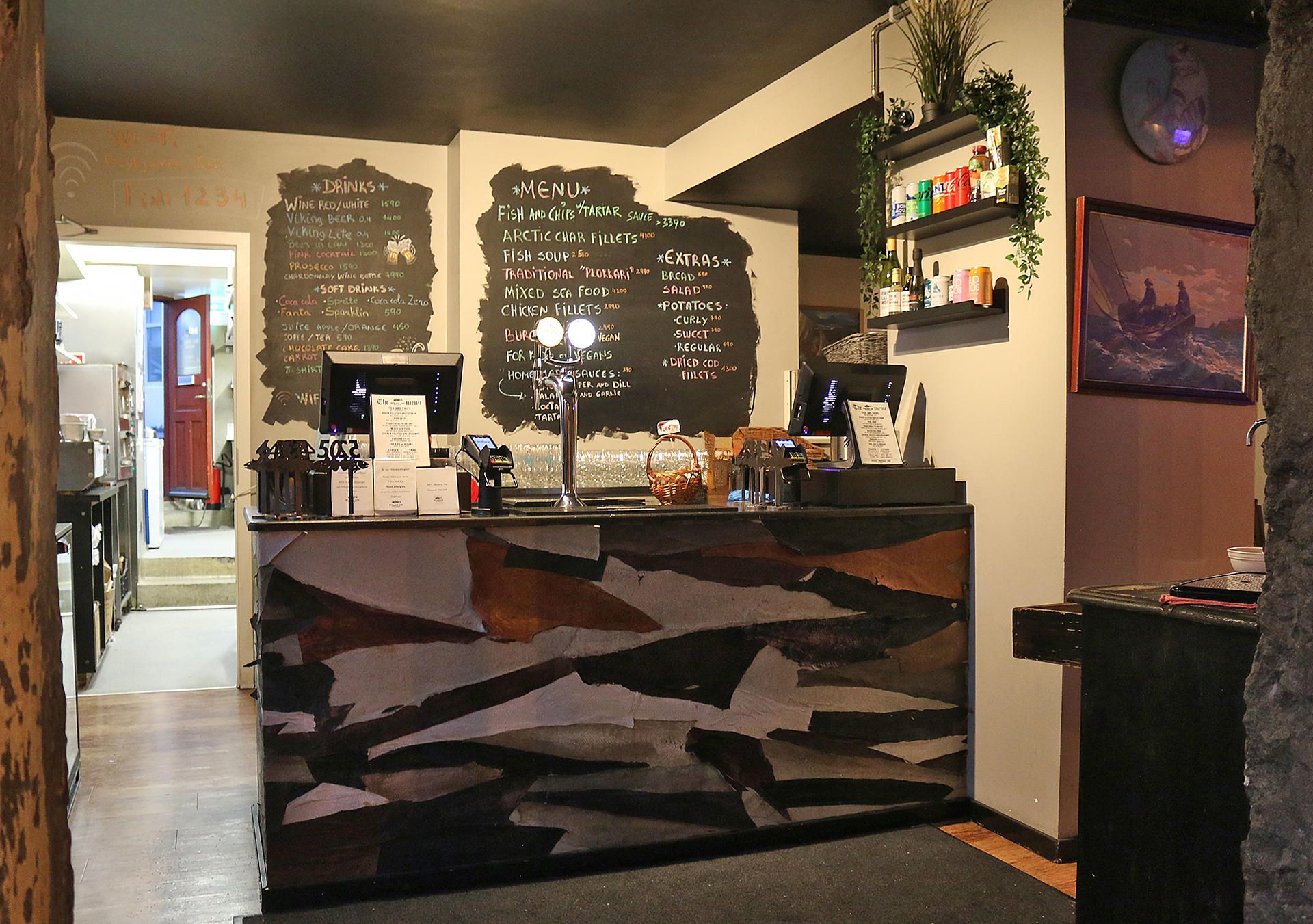 a counter with a menu on the wall