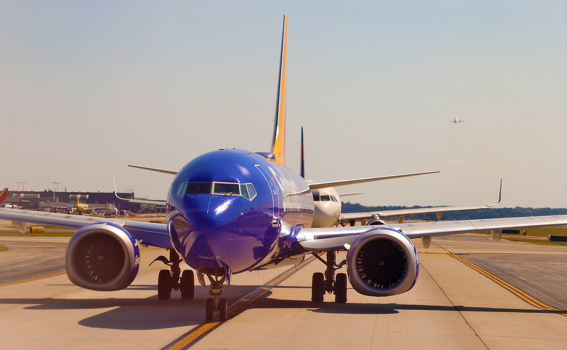 a blue airplane on a runway