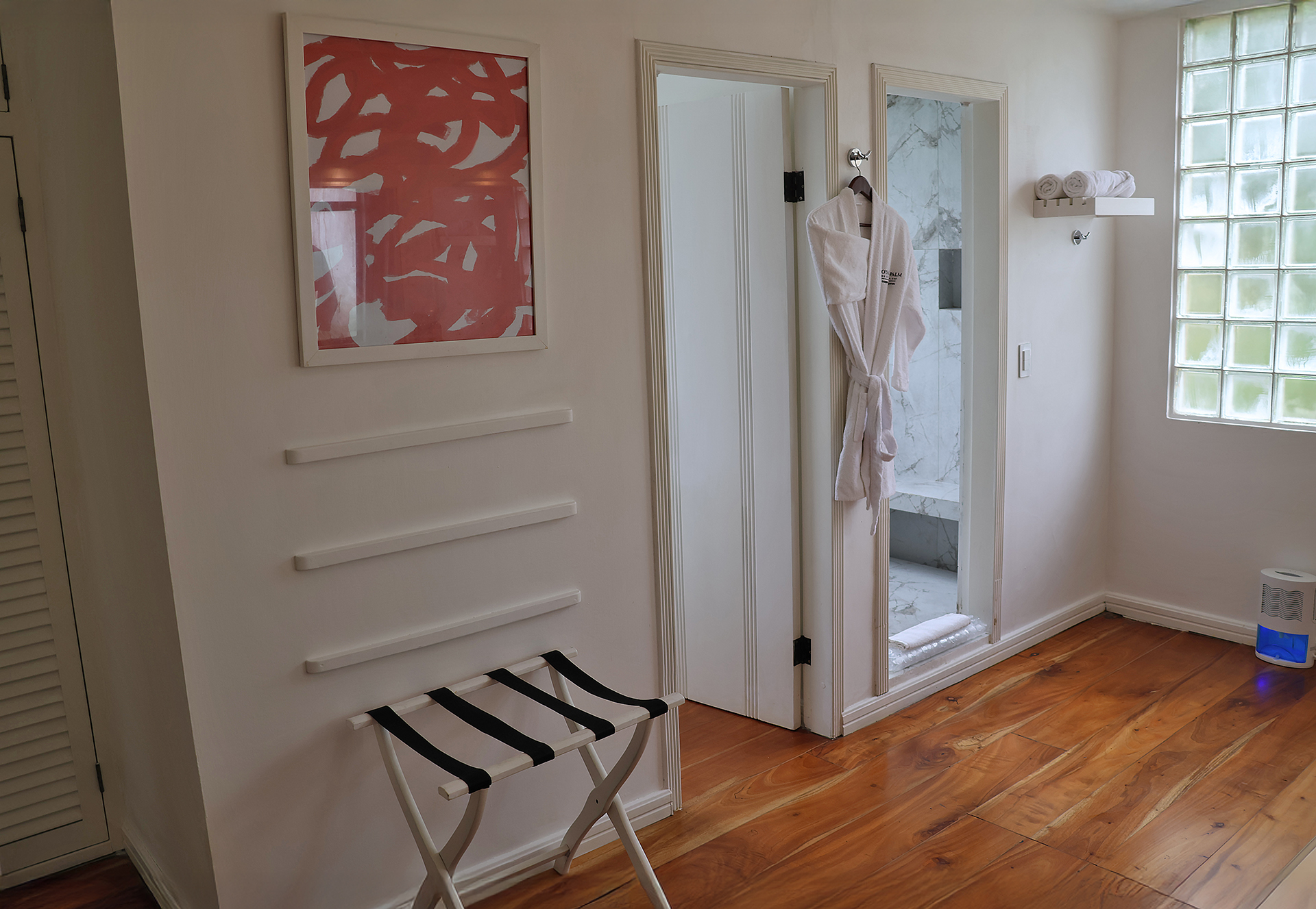 a white robe on a hook in a room