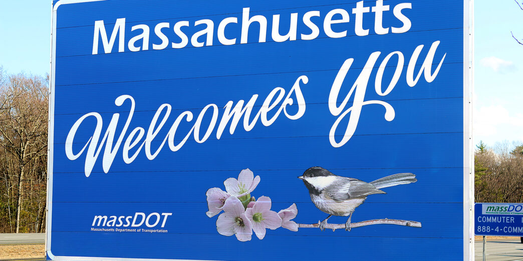 a blue sign with a bird and flowers on it