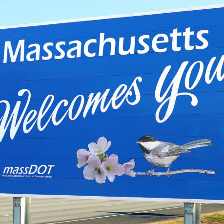 a blue sign with a bird and flowers on it