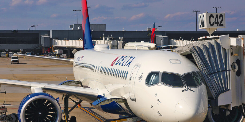 a white airplane with a red and blue tail