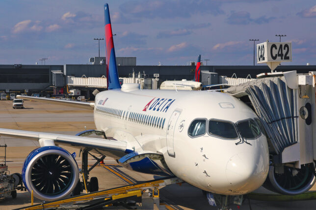 a white airplane with a red and blue tail