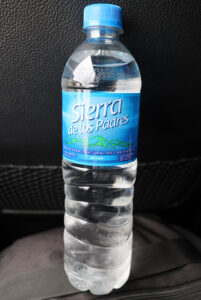 a bottle of water with a blue label