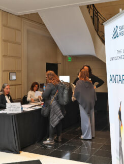 a group of women standing in front of a table