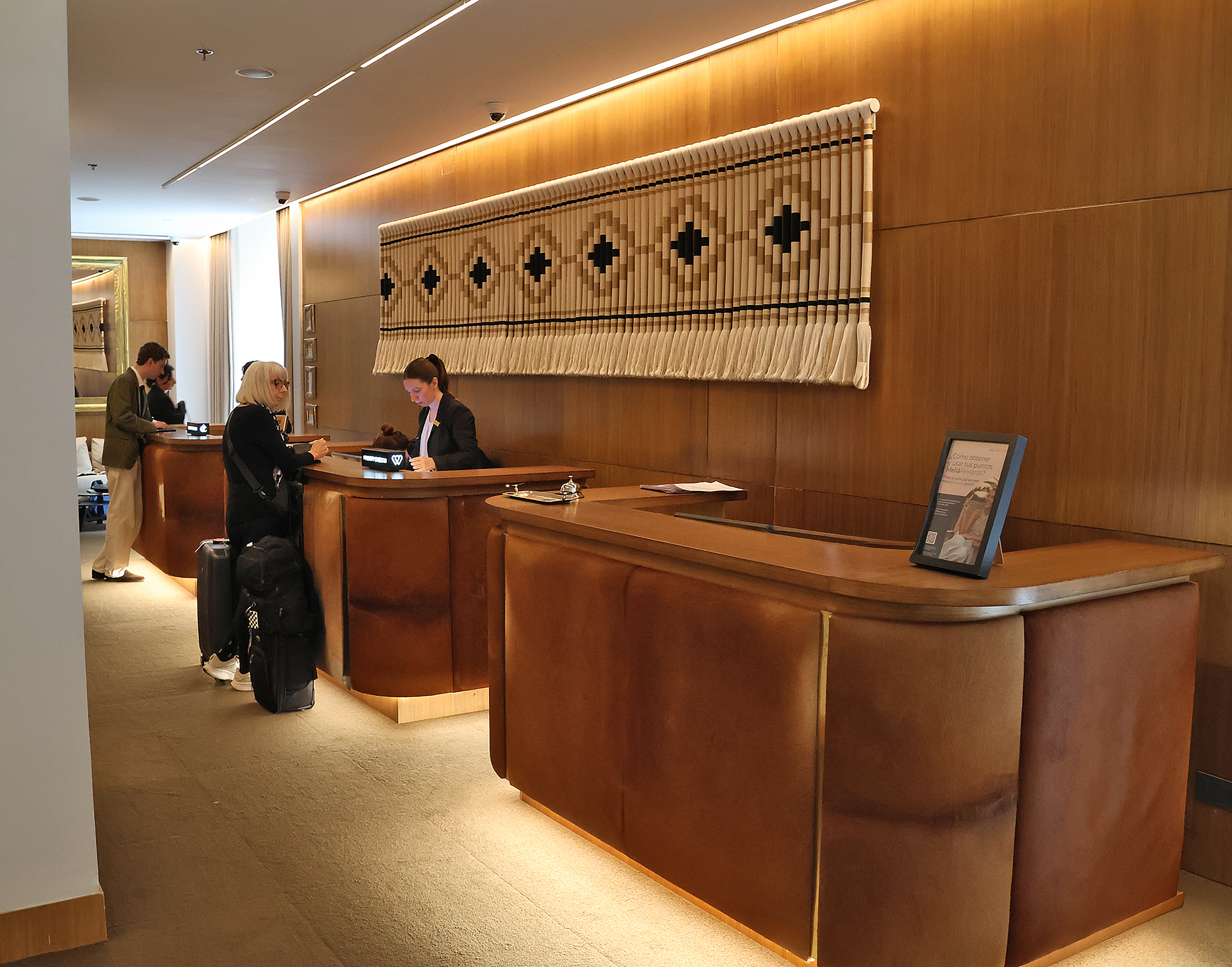 people standing at a reception desk