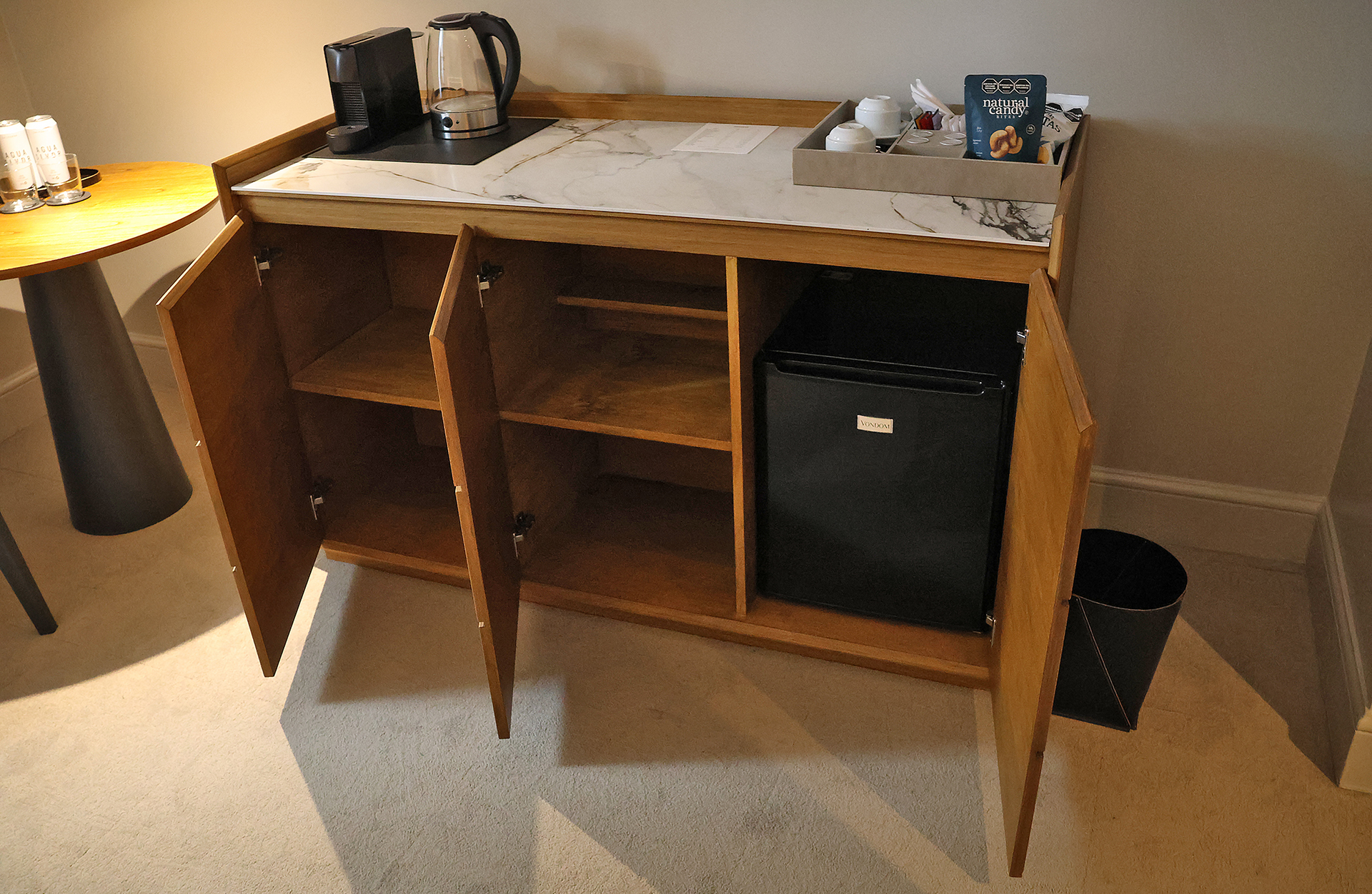 a counter with a coffee pot and a tray on it
