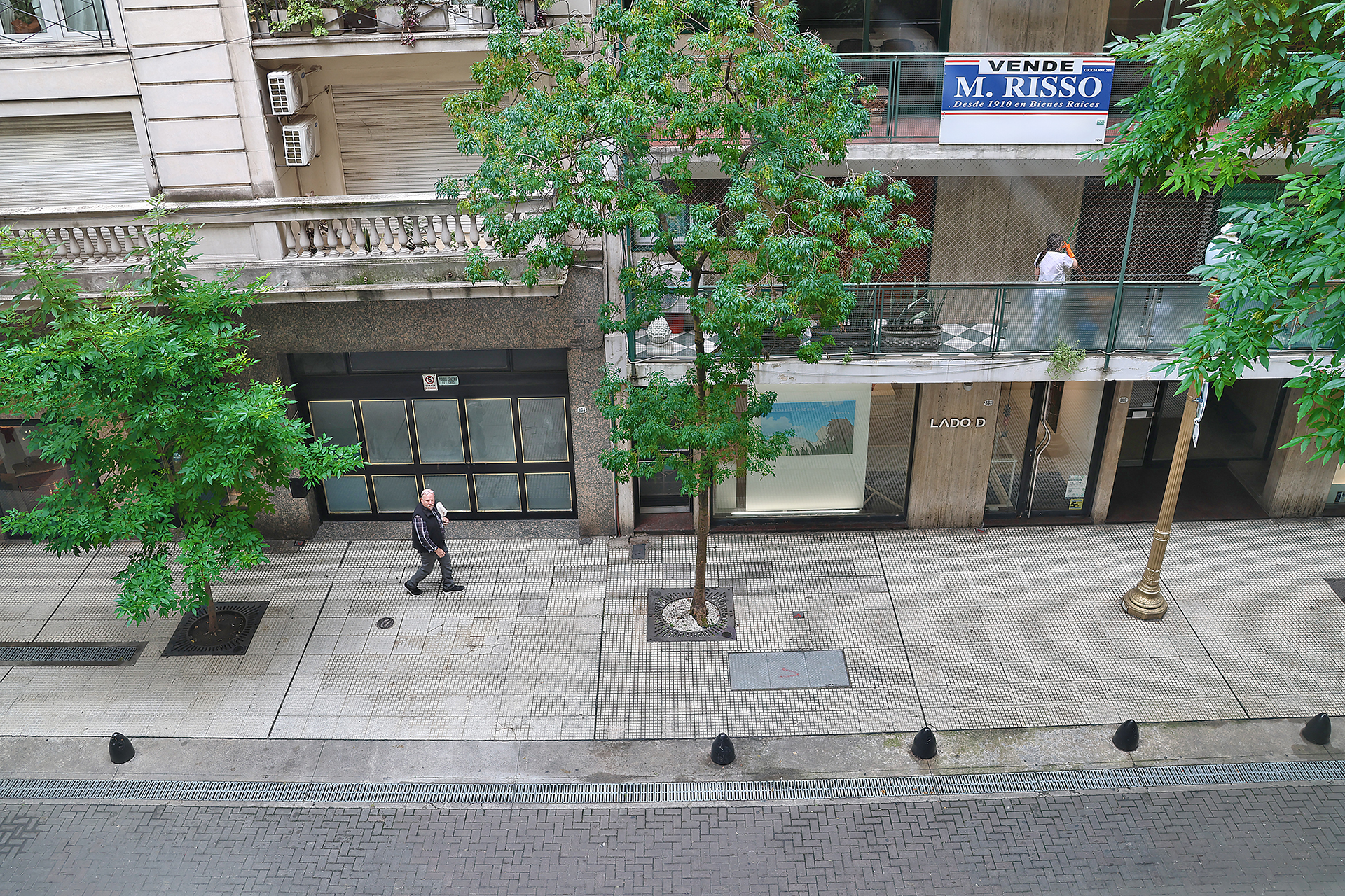 a man walking on a sidewalk