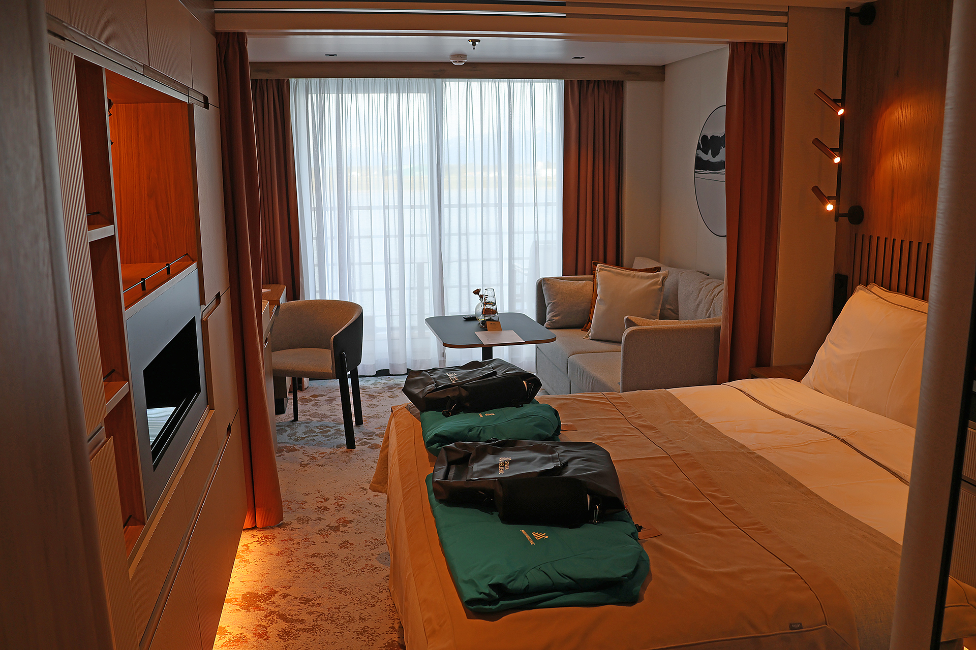 a room with a bed and a television