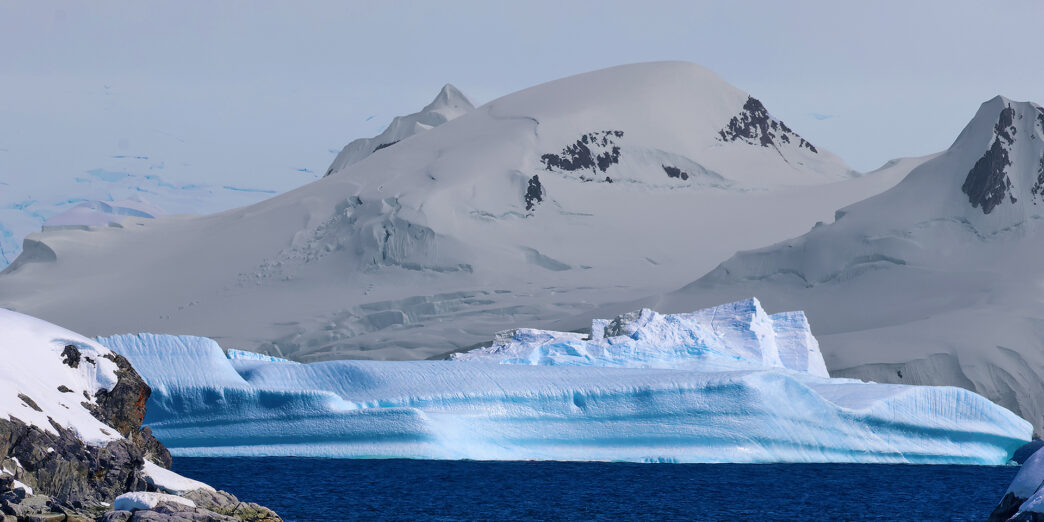 a snowy mountain and water