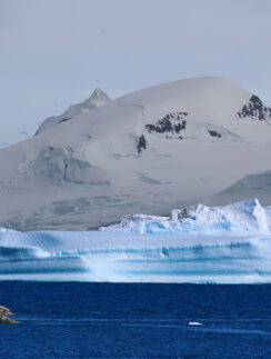a snowy mountain and water