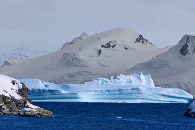 a snowy mountain and water