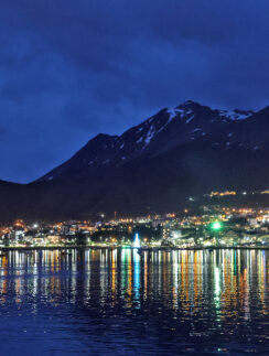 a city lights reflecting on water