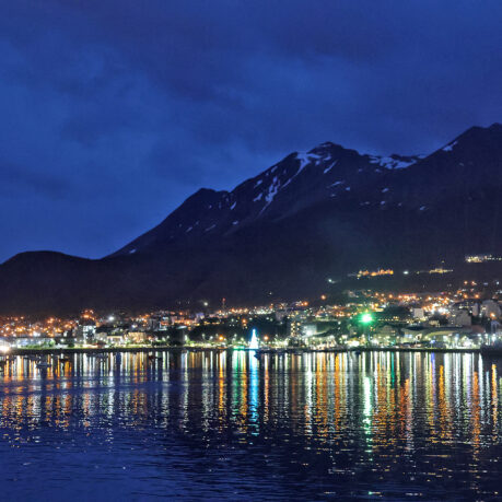 a city lights reflecting on water