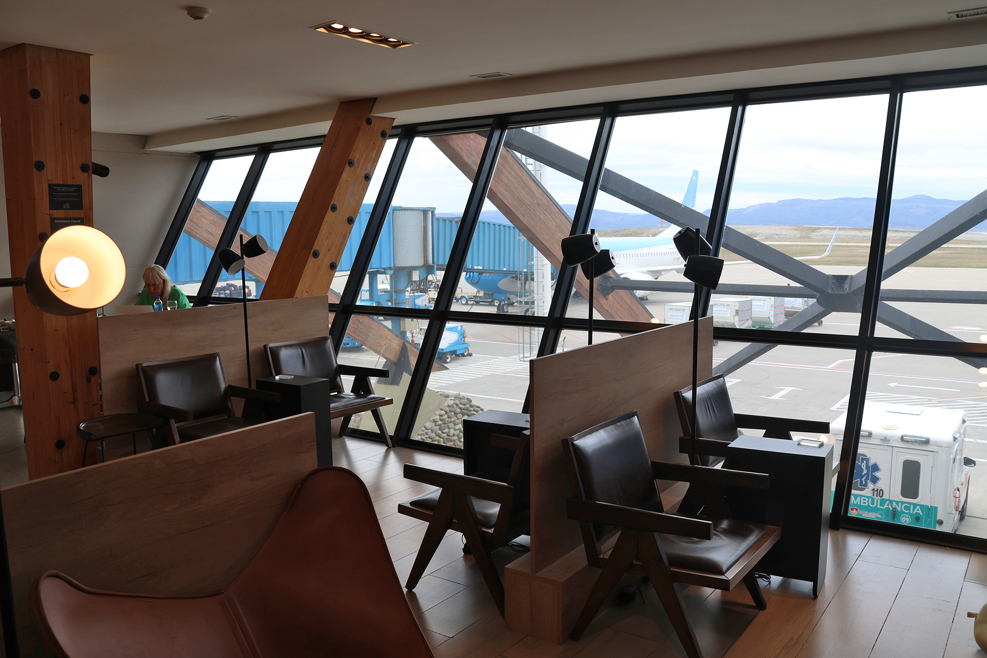 a room with chairs and tables and windows