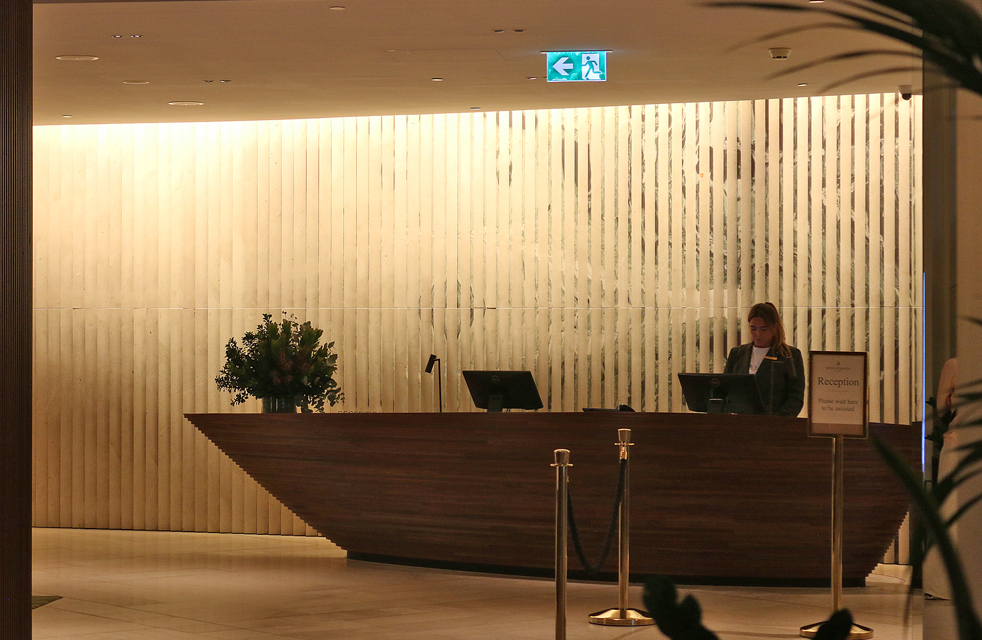 a woman standing behind a desk