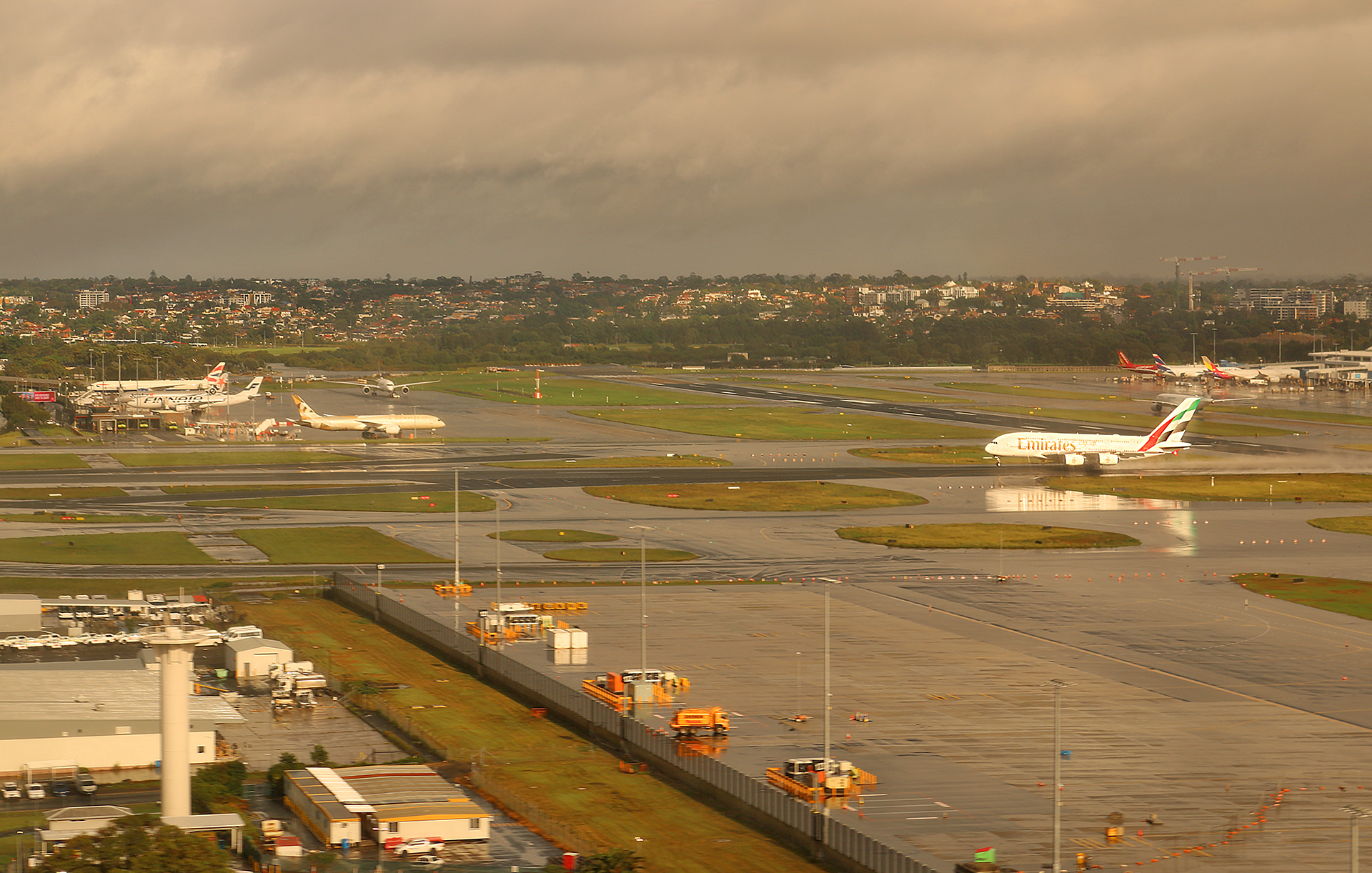 an airport with a runway and buildings in the background
