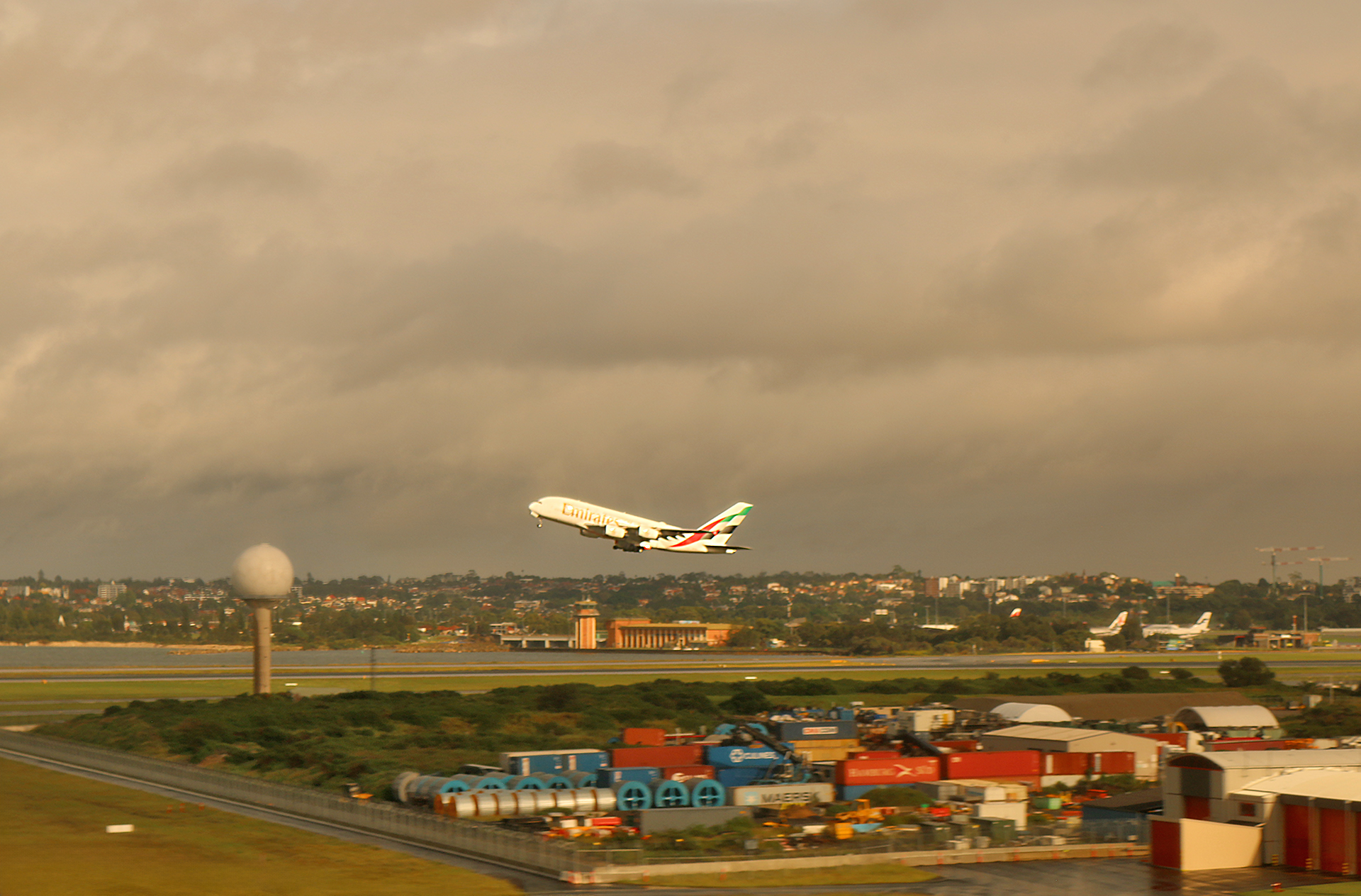 an airplane flying over a runway