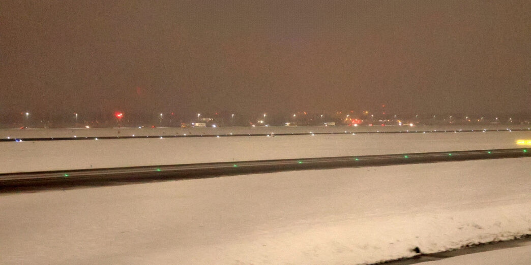 a snowy runway at night