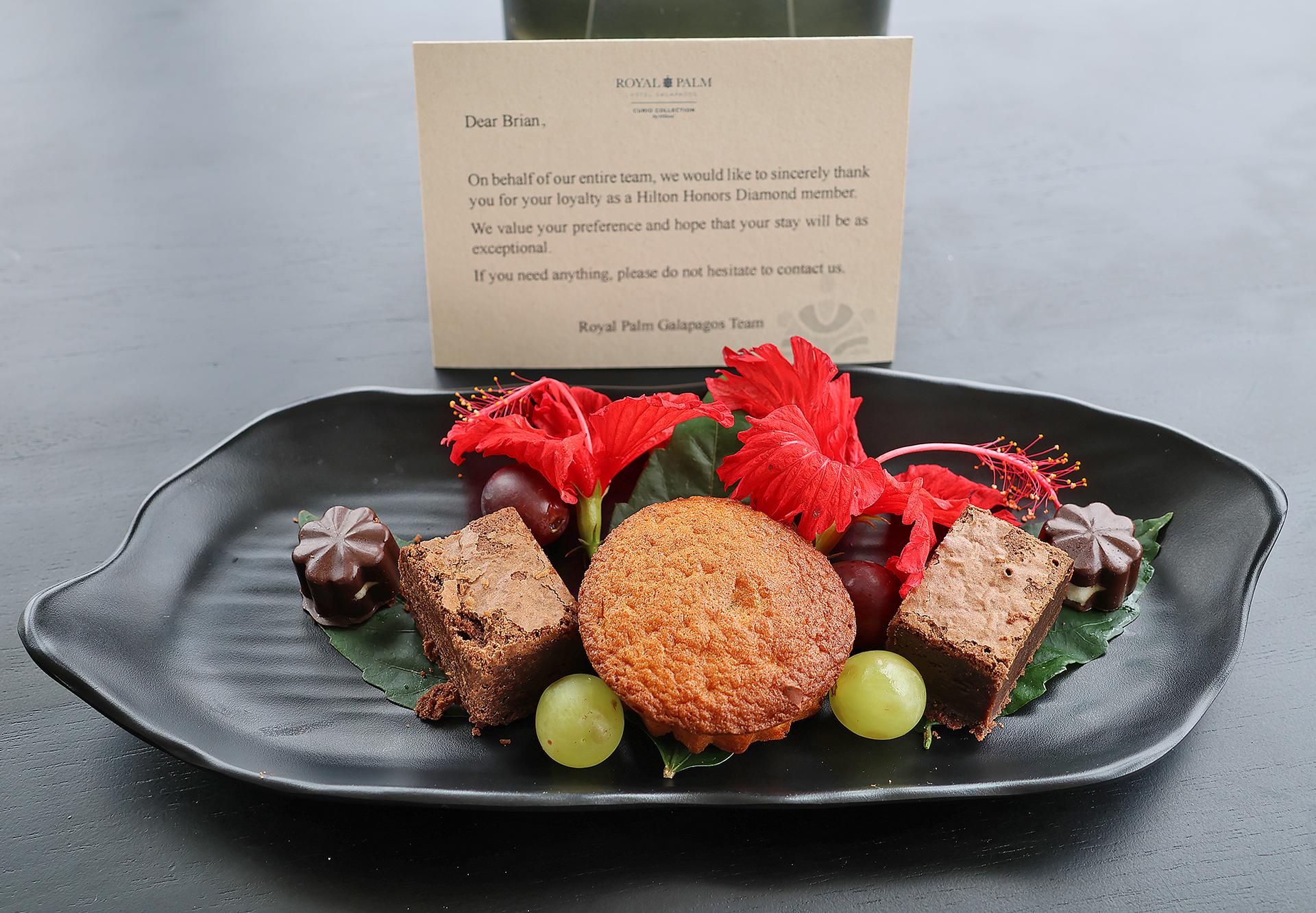 a plate of dessert with flowers and a note