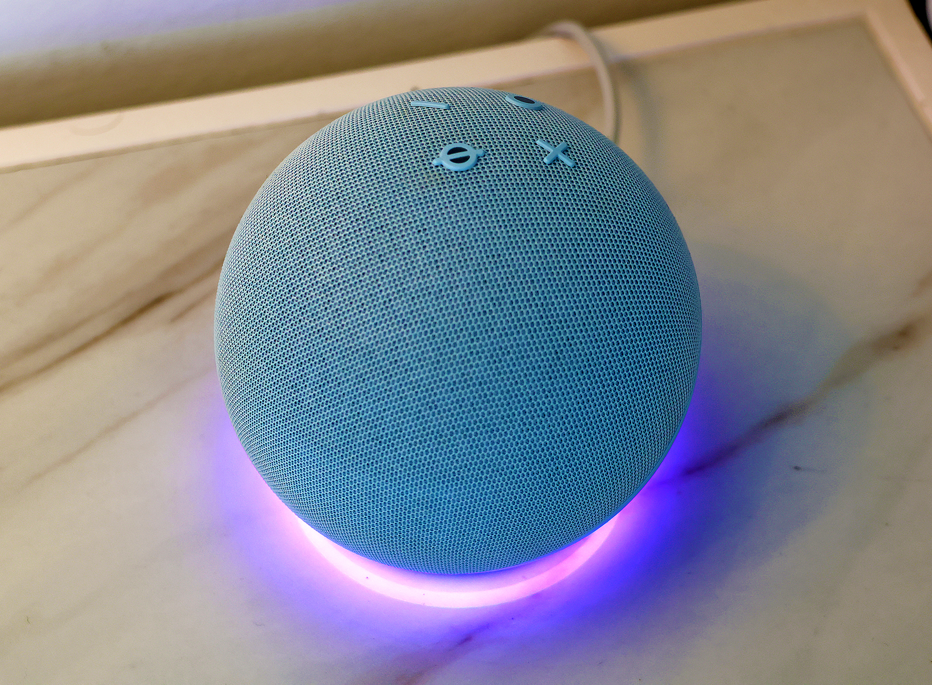 a blue round object with a small cross on it