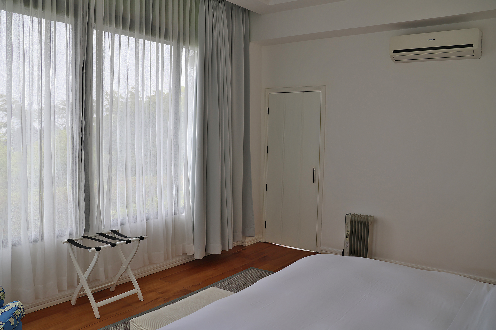 a bedroom with a bed and a chair