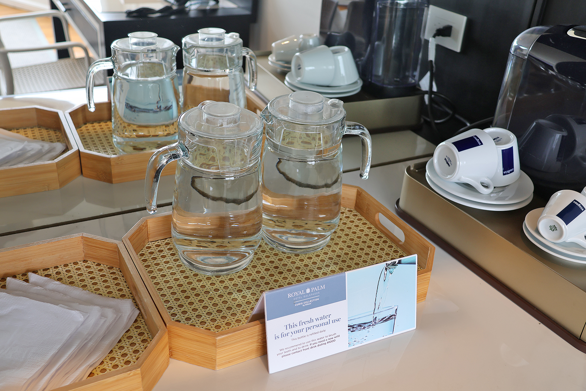 a group of clear water glasses on a tray