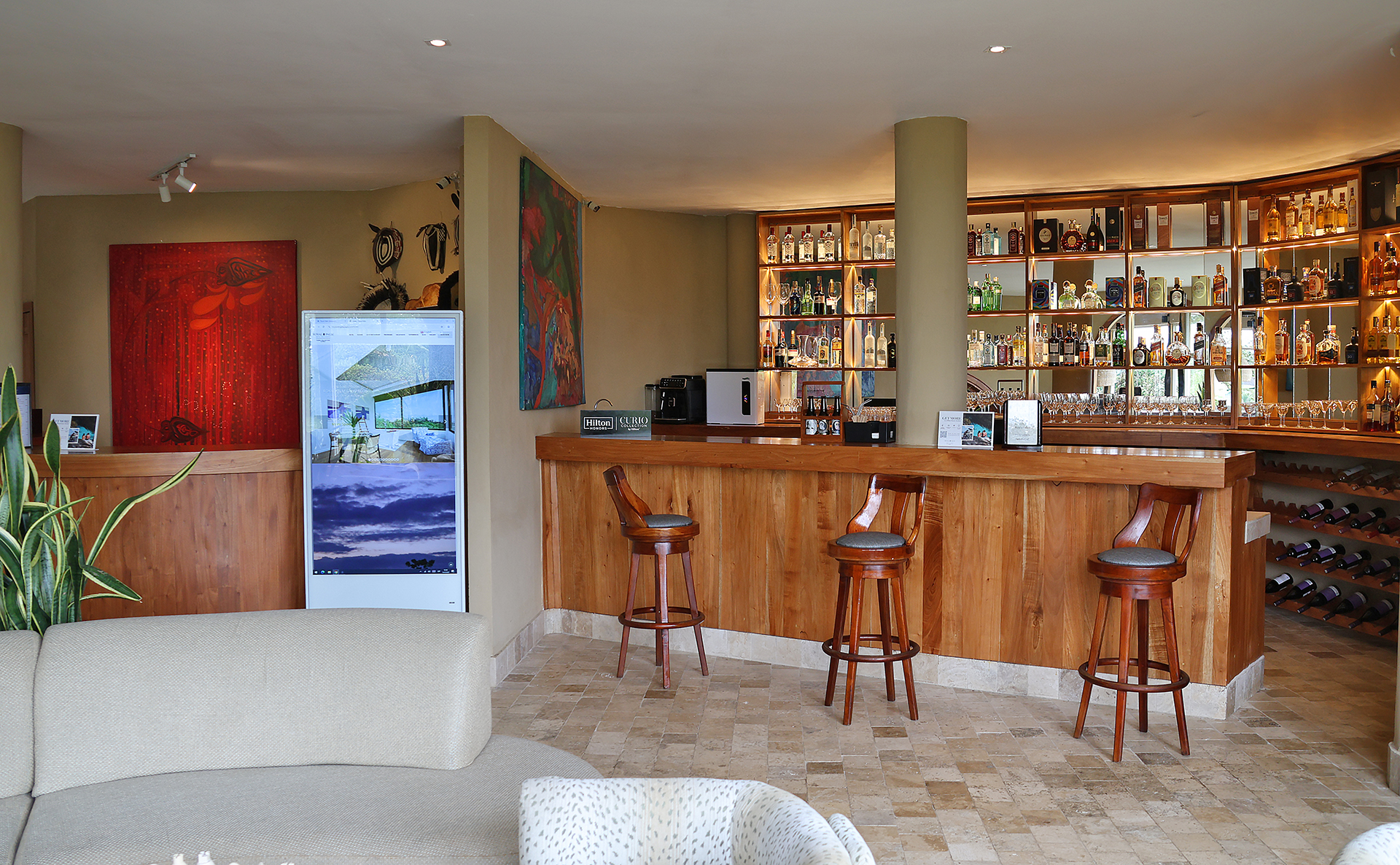 a bar with stools and shelves in a room