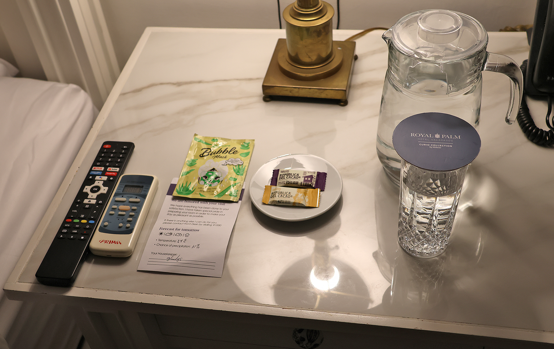 a table with a glass of water and a plate of food