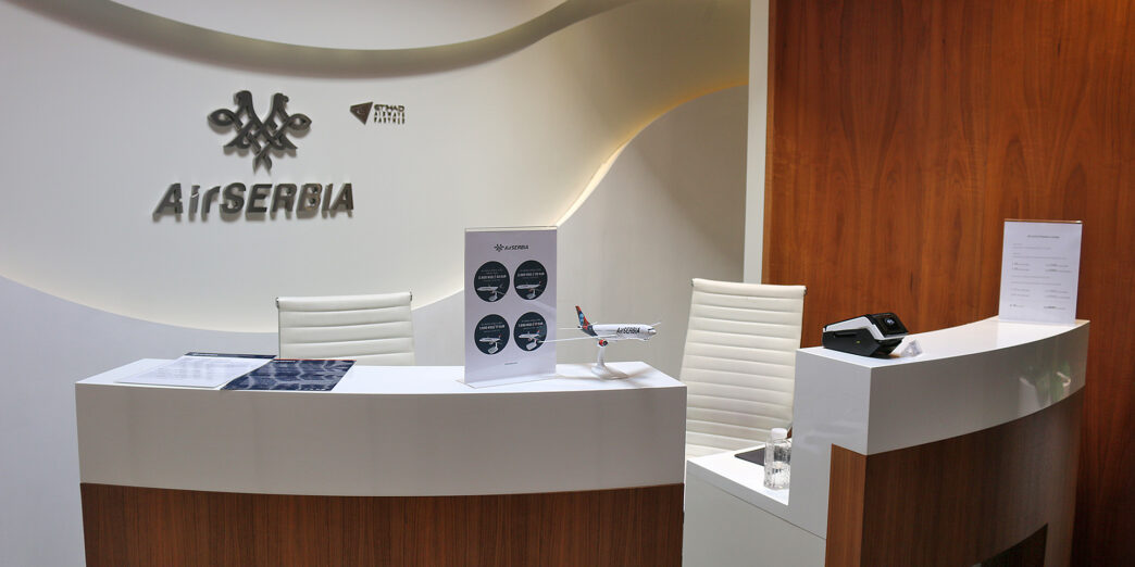 a desk with a sign and a phone