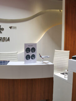 a desk with a sign and a phone