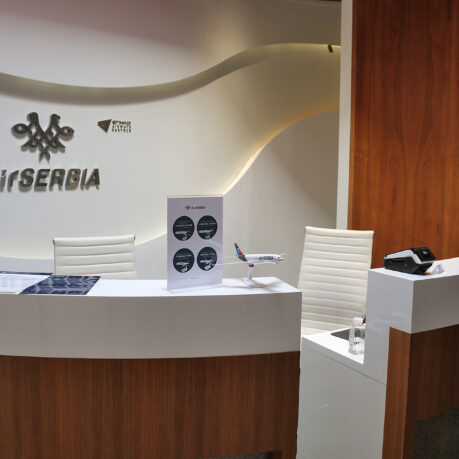 a desk with a sign and a phone