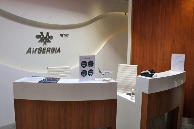 a desk with a sign and a phone