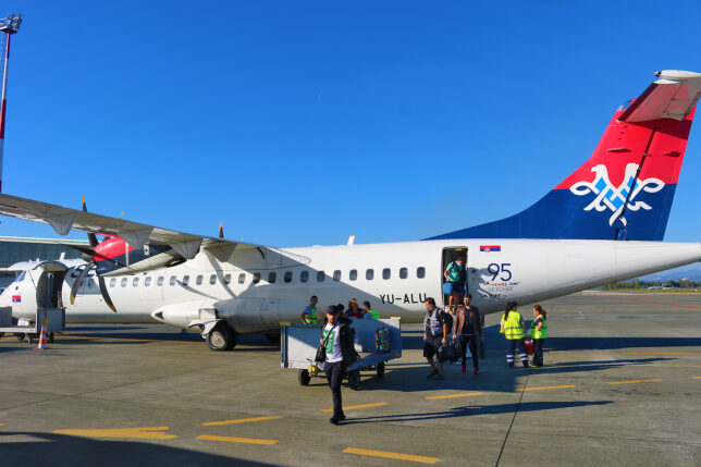 a group of people boarding an airplane