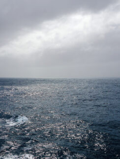 a body of water with clouds in the sky